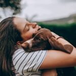 a woman holding a dog