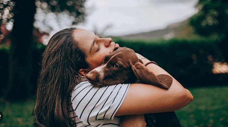 a woman holding a dog