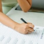 person filling details on a form